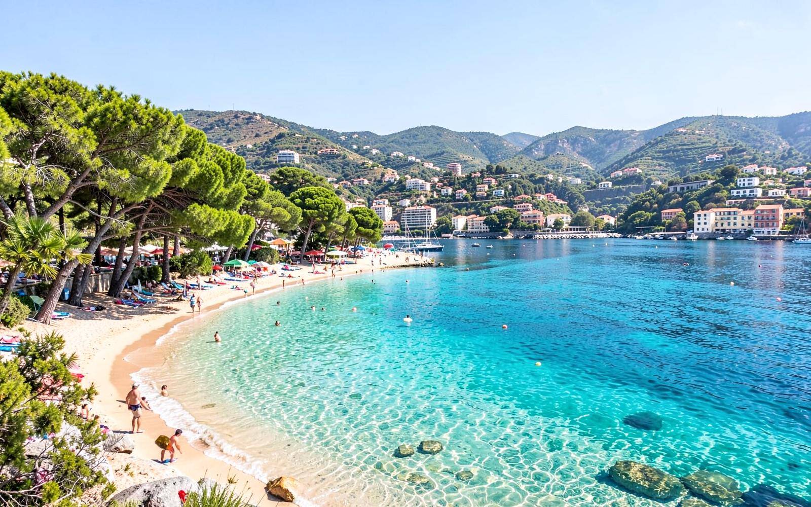 The bay at Santa Ponsa in Mallorca with clear water and a curving sandy beach